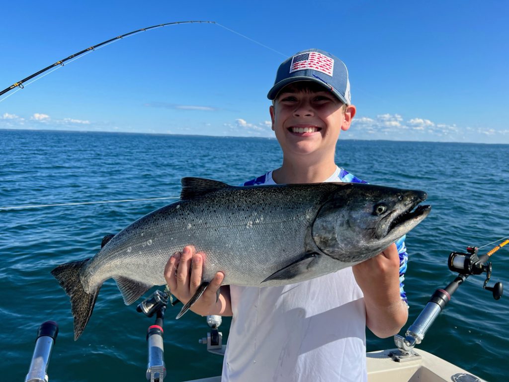 Cody with a king caught aboard Hat Trick Charters.